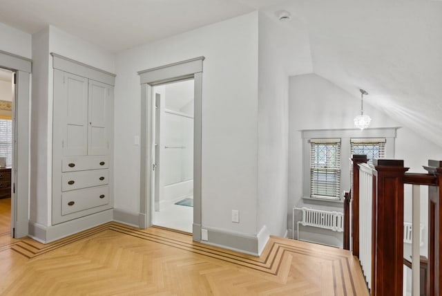 interior space with baseboards, an upstairs landing, and vaulted ceiling