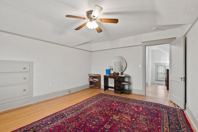 interior space featuring wood finished floors and ceiling fan