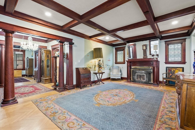 living room with a chandelier, ornate columns, baseboards, and coffered ceiling