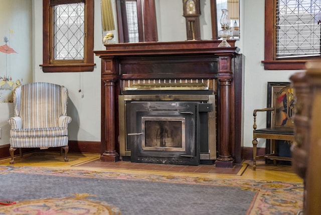 details featuring a fireplace with flush hearth and baseboards