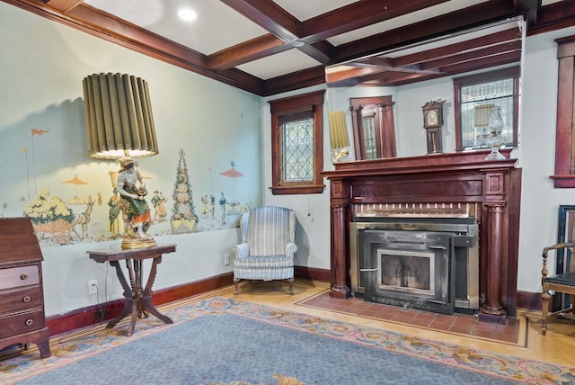 sitting room with a fireplace with flush hearth, baseboards, beam ceiling, and coffered ceiling