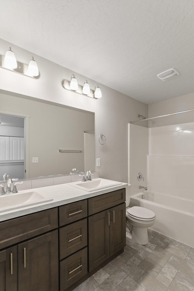 full bathroom featuring shower / tub combination, toilet, a textured ceiling, and vanity