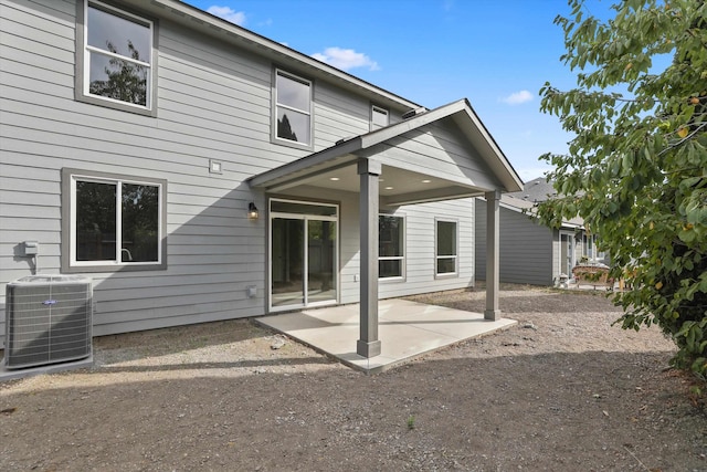 rear view of house featuring cooling unit and a patio