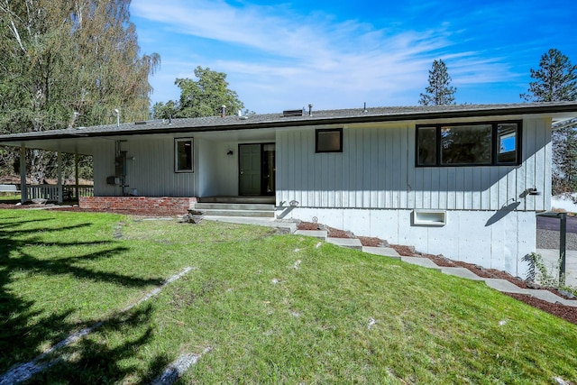 rear view of property with a yard