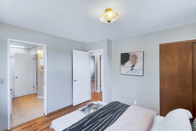 bedroom with a closet and light hardwood / wood-style floors