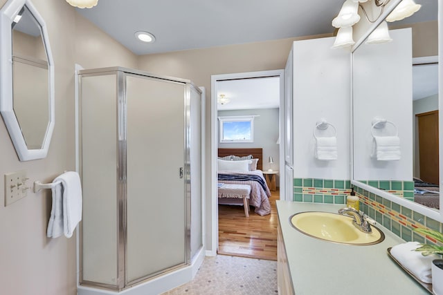 bathroom with vanity, tasteful backsplash, and walk in shower