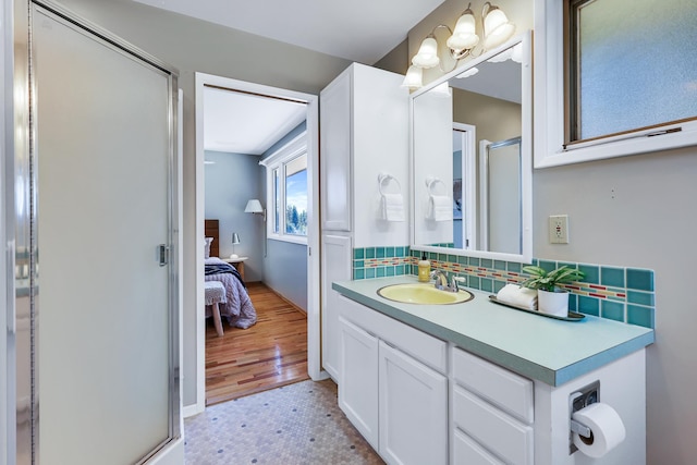 bathroom featuring tile patterned floors, vanity, and a shower with shower door