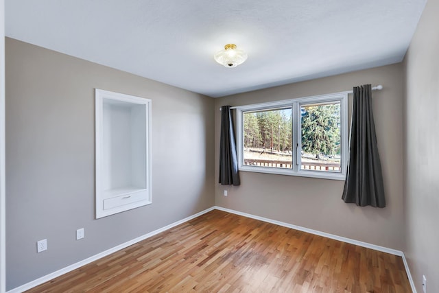 spare room featuring hardwood / wood-style floors