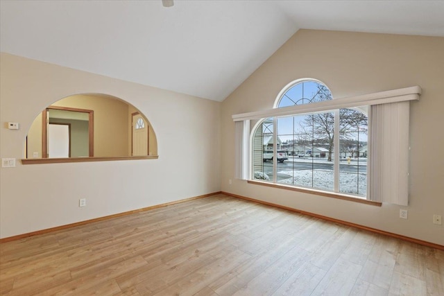 empty room with lofted ceiling and light hardwood / wood-style floors