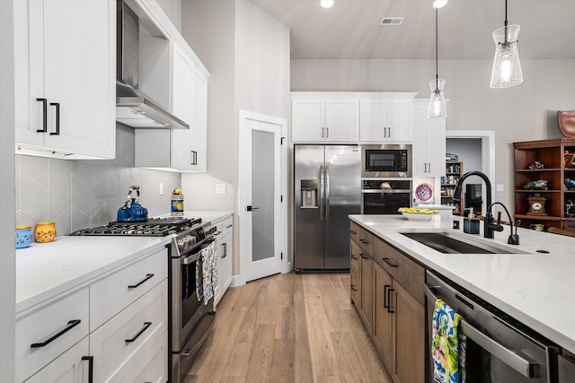 kitchen with sink, white cabinets, and stainless steel appliances