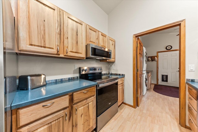 kitchen featuring stainless steel appliances and light hardwood / wood-style flooring