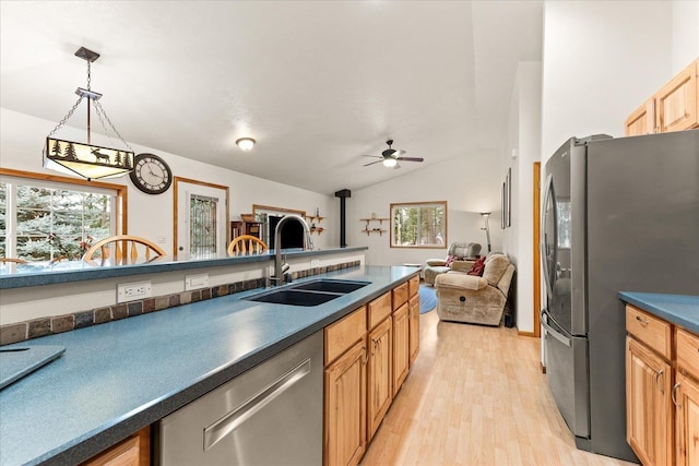 kitchen with ceiling fan, stainless steel appliances, decorative light fixtures, light hardwood / wood-style flooring, and sink