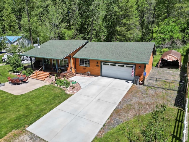 view of front of house with a front lawn, a garage, and a porch