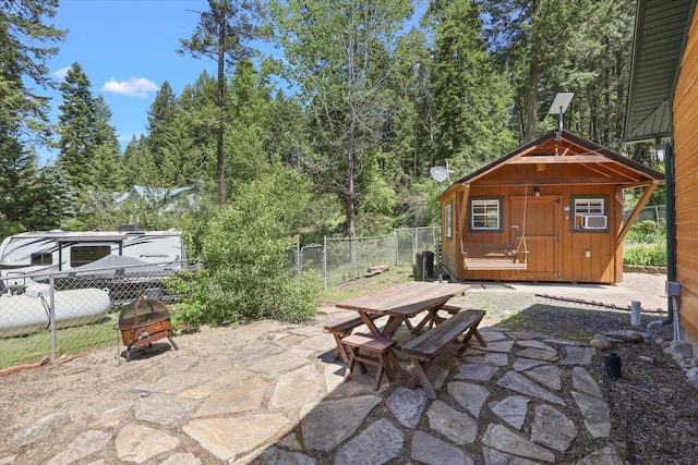 view of patio with cooling unit and a storage unit