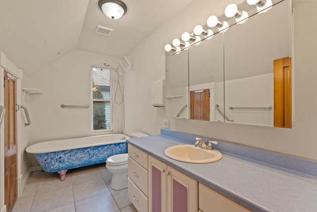 bathroom with lofted ceiling, vanity, tile patterned flooring, toilet, and a bath