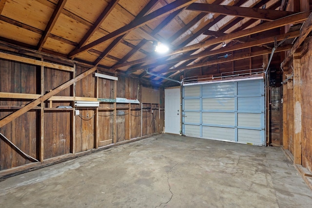 garage featuring wood walls