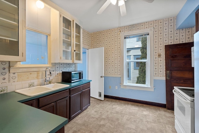 kitchen featuring ceiling fan, sink, light colored carpet, and white electric stove