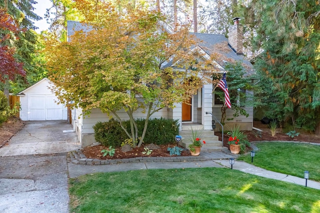 view of front of property with a storage shed, a front lawn, and a garage