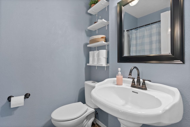 bathroom with toilet and sink