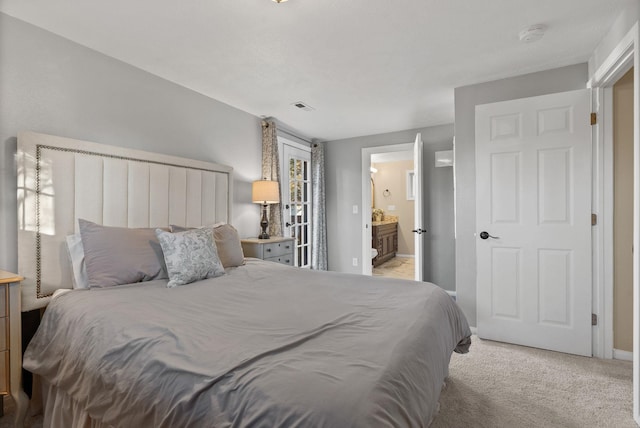 carpeted bedroom with ensuite bathroom