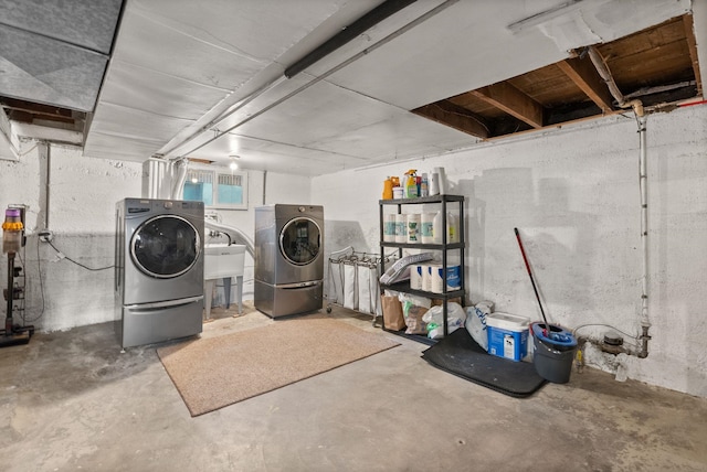 laundry area featuring sink and separate washer and dryer