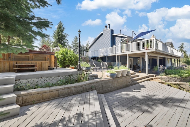 wooden terrace with a patio area and a hot tub