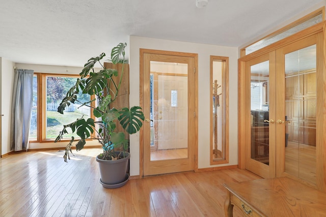 entrance foyer featuring light hardwood / wood-style flooring and french doors