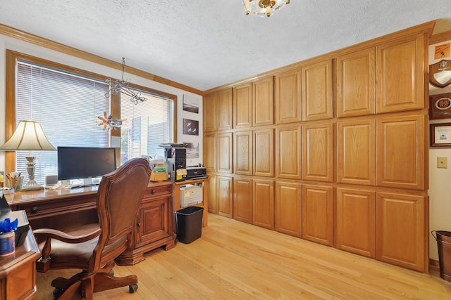 office space featuring a textured ceiling, ornamental molding, and light hardwood / wood-style flooring