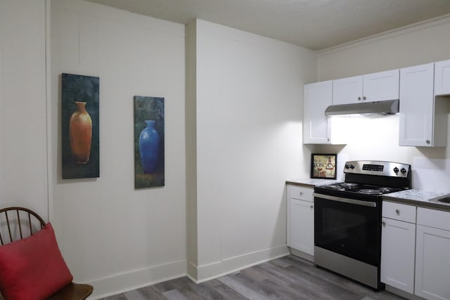 kitchen with wood-type flooring, electric range, and white cabinets