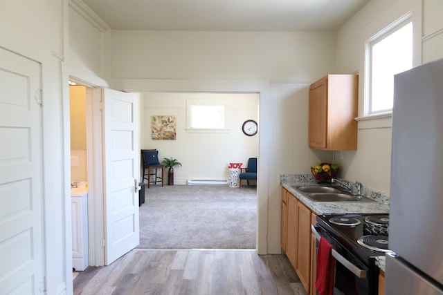 kitchen featuring light colored carpet, a baseboard heating unit, sink, black range with electric cooktop, and stainless steel fridge