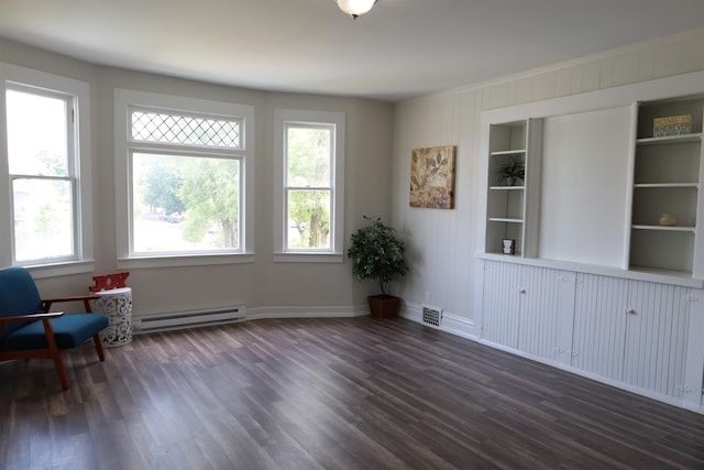 sitting room featuring built in features, a baseboard radiator, and dark hardwood / wood-style flooring