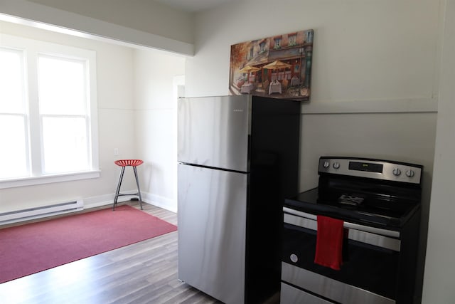 kitchen featuring stainless steel appliances, hardwood / wood-style floors, and a baseboard radiator