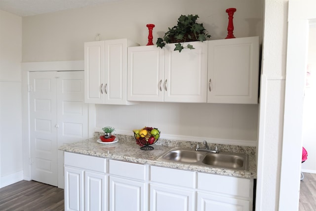 kitchen featuring sink, white cabinetry, and hardwood / wood-style floors