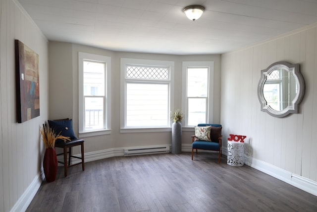 unfurnished room featuring baseboard heating and dark hardwood / wood-style floors