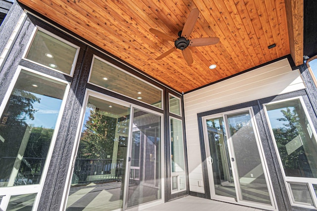 exterior space featuring ceiling fan and wood ceiling