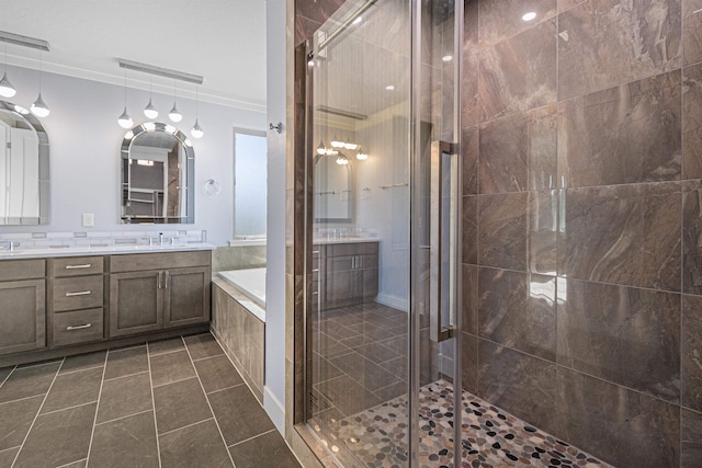 bathroom featuring tile patterned flooring, vanity, crown molding, and shower with separate bathtub