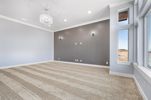 empty room featuring crown molding, a chandelier, and carpet flooring