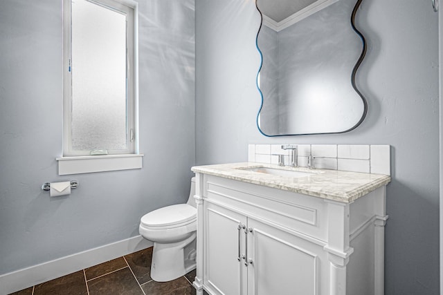 bathroom featuring toilet, ornamental molding, tile patterned floors, and vanity