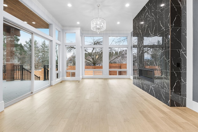 unfurnished sunroom featuring an inviting chandelier