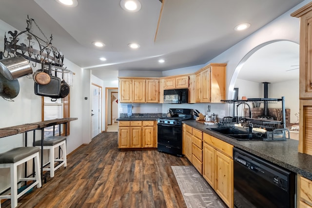 kitchen with black appliances, dark wood-type flooring, sink, and light brown cabinets