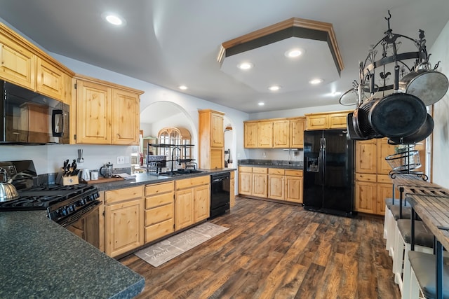 kitchen with dark wood-type flooring, sink, light brown cabinets, and black appliances