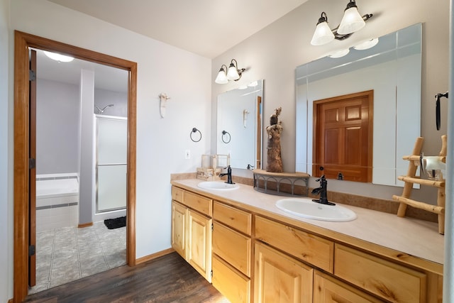 bathroom featuring wood-type flooring, vanity, and separate shower and tub