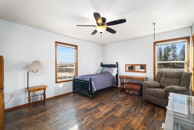 bedroom with ceiling fan and dark hardwood / wood-style flooring