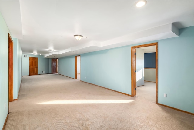 basement featuring light colored carpet