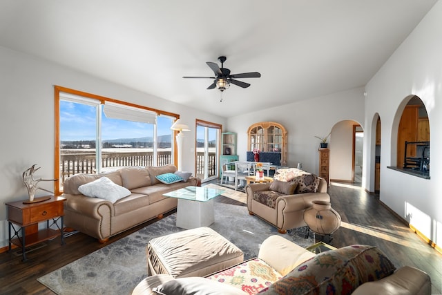 living room with ceiling fan and dark hardwood / wood-style floors