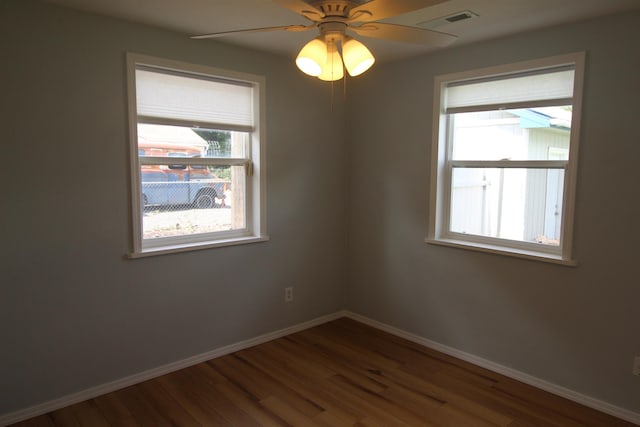 empty room featuring dark wood-type flooring and ceiling fan