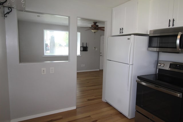 kitchen featuring white cabinets, light wood-type flooring, ceiling fan, and appliances with stainless steel finishes