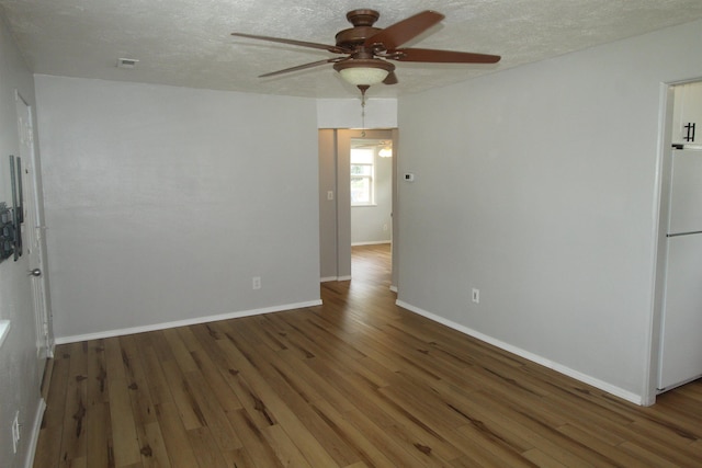 unfurnished room featuring ceiling fan, a textured ceiling, and dark hardwood / wood-style flooring