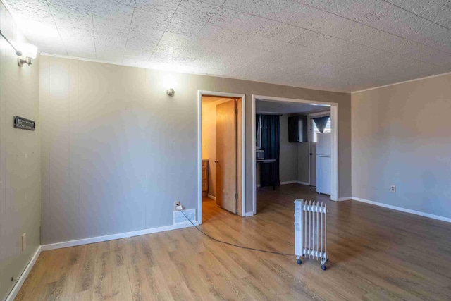 empty room with hardwood / wood-style floors