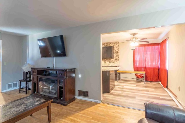 living room featuring hardwood / wood-style floors and ceiling fan